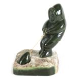 AN ORIENTAL CARVED JADE SCULPTURE OF AN ESKIMO