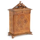 A 19TH CENTURY BLACK FOREST CARVED WALNUT WRITING TABLE CABINET