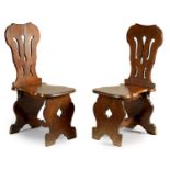 A PAIR OF EARLY GEORGE III MAHOGANY 'SGABELLO' TYPE HALL CHAIRS