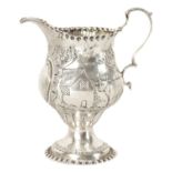 AN UNUSUAL GEORGE II SILVER AND GILT CREAM JUG