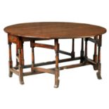 A LARGE EARLY 18TH CENTURY EIGHT SEATER YEW WOOD DOUBLE GATE LEG TABLE