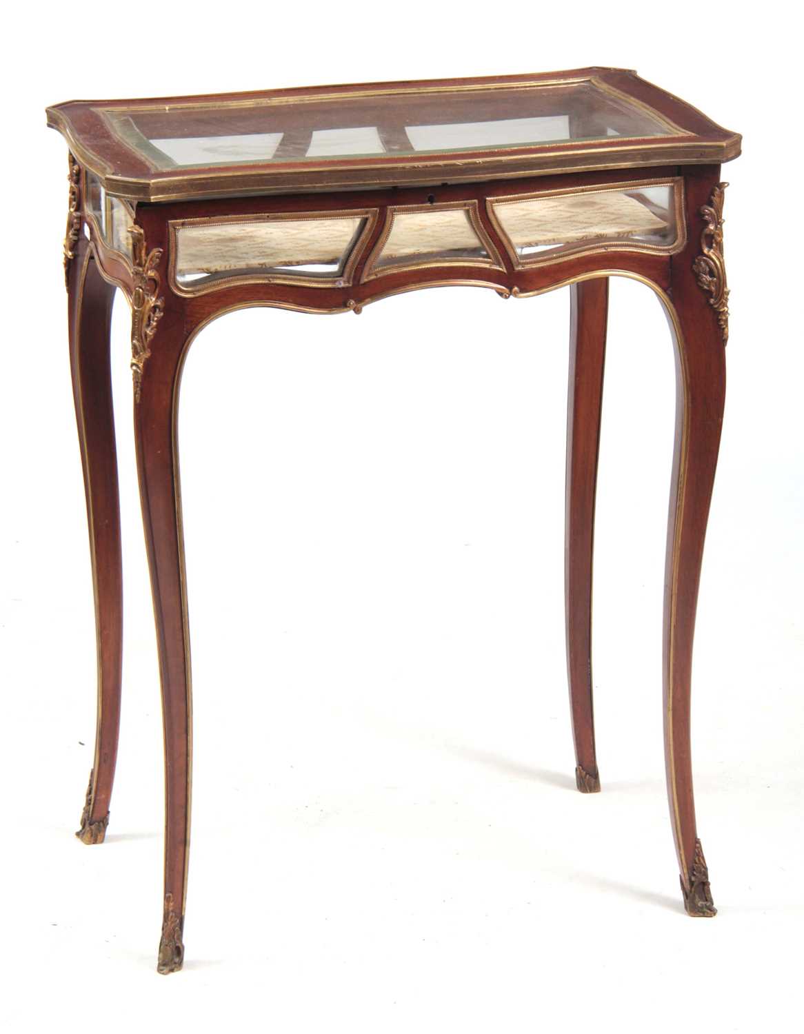 A 19TH CENTURY ORMOLU MOUNTED SERPENTINE SHAPED MAHOGANY BIJOUTERIE TABLE