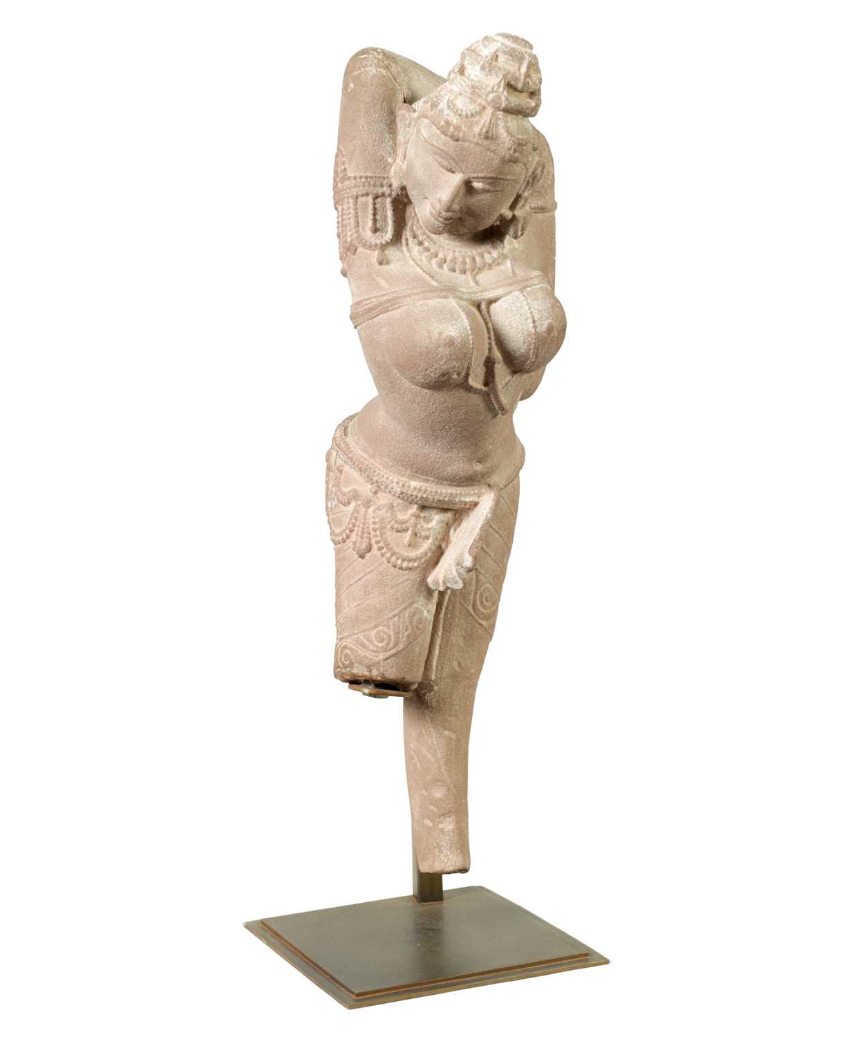 A 12TH CENTURY CARVED RED SANDSTONE NORTHERN INDIAN APSARA FIGURE