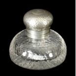 AN EDWARDIAN CIRCULAR SILVER AND GLASS INKWELL