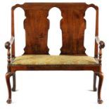 A GEORGE I FIGURED WALNUT TWO SEATER SETTEE