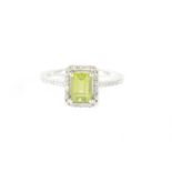 A 9CT WHITE GOLD PERIDOT AND DIAMOND RING