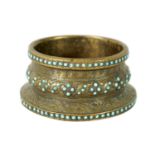 A 19TH CENTURY PERSIAN JEWELLED TURQUOISE GILT METAL BANGLE