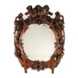 A 19TH CENTURY WALNUT BLACK FOREST CARVED HANGING MIRROR