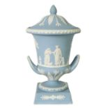 A WEDGWOOD PALE BLUE JASPER WARE TWO HANDLED URN SHAPED VASES AND COVERS ON PEDESTAL BASES