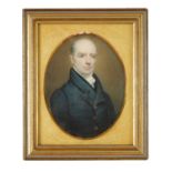 A 19TH CENTURY OVAL HALF LENGTH PORTRAIT MINIATURE ON IVORY OF A GENTLEMAN
