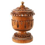 AN UNUSUAL LATE REGENCY OAK URN SHAPED TEA CADDY