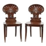 A FINE PAIR OF REGENCY MAHOGANY HALL CHAIRS IN THE MANNER OF GILLOWS