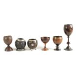 A COLLECTION OF SIX LATE 18TH CENTURY CARVED COCONUT AND TREEN WARE CUPS