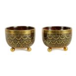A PAIR OF BRASS INLAID COCONUT SHELL BOWLS