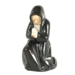 FRIAR, KNEELING MONK. A ROYAL WORCESTER PORCELAIN CANDLE EXTINGUISHER