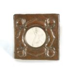AN ARTS AND CRAFTS HAMMERED AND EMBOSSED COPPER EASEL PHOTOGRAPH FRAME