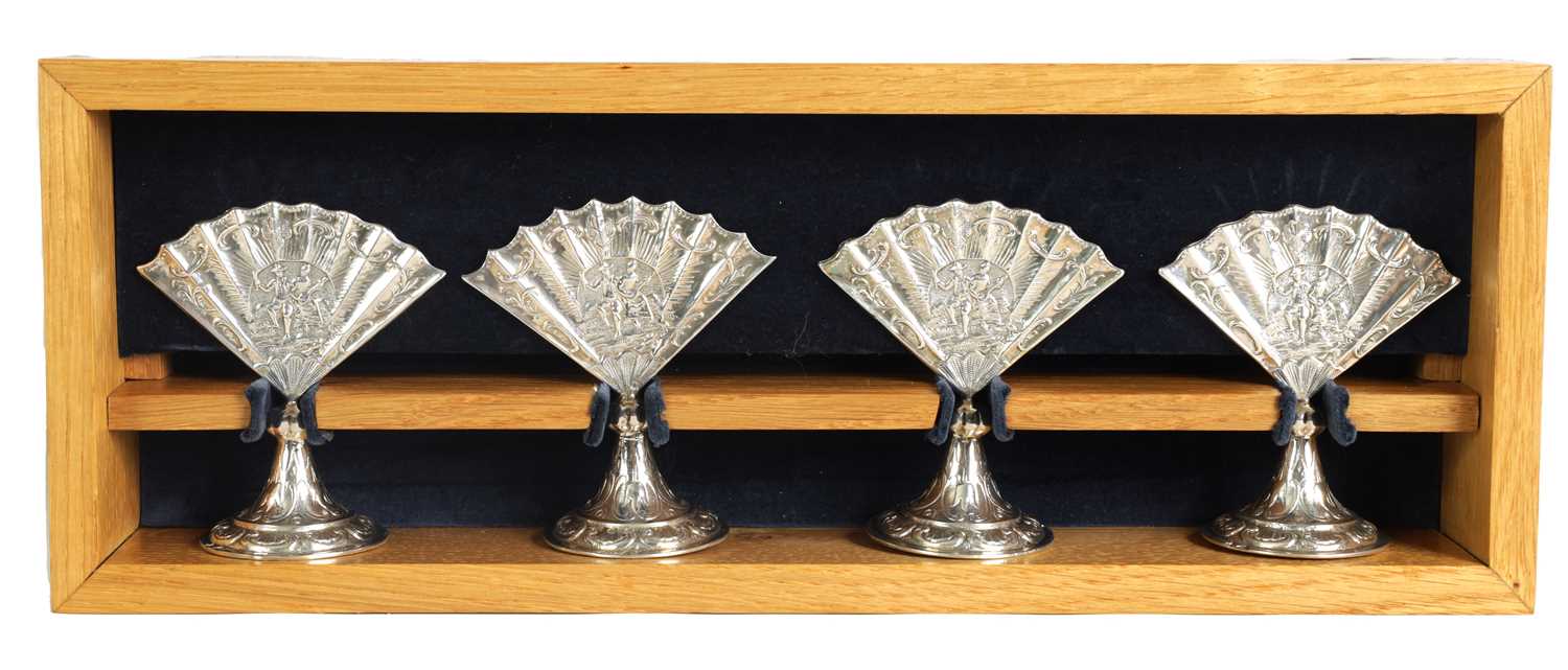 A CASED SET OF FOUR LATE VICTORIAN NOVELTY SILVER MENU HOLDERS MODELLED AS FANS