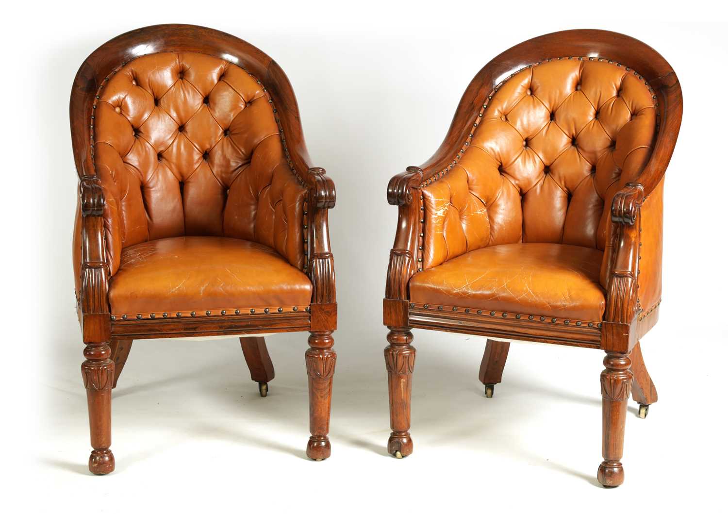 A PAIR OF REGENCY FIGURED ROSEWOOD AND TAN LEATHER BUTTON UPHOLSTERED LIBRARY CHAIRS