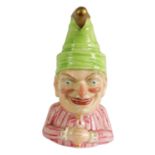 A RARE ROYAL WORCESTER “MR PUNCH” CANDLE EXTINGUISHER