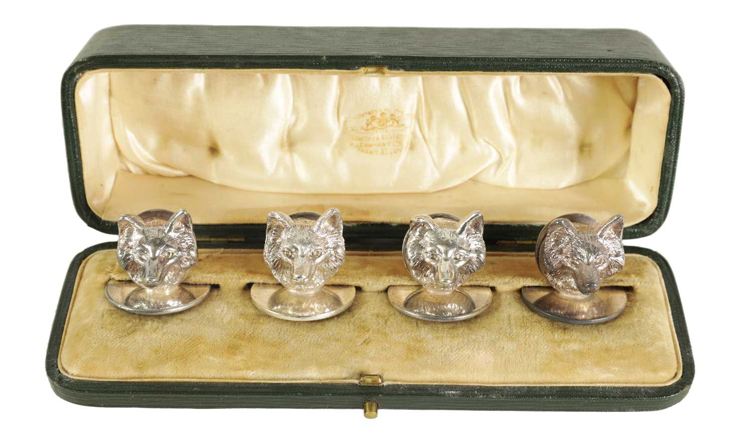 A CASED SET OF FOUR FOX MASK MENU HOLDERS