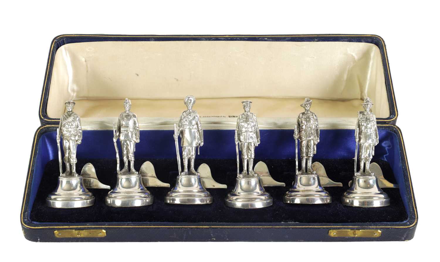 A LARGE AND RARE CASED COMPLETE SET OF SIX SILVER 'SOLDIERS OF THE EMPIRE' FIGURAL MENU HOLDERS