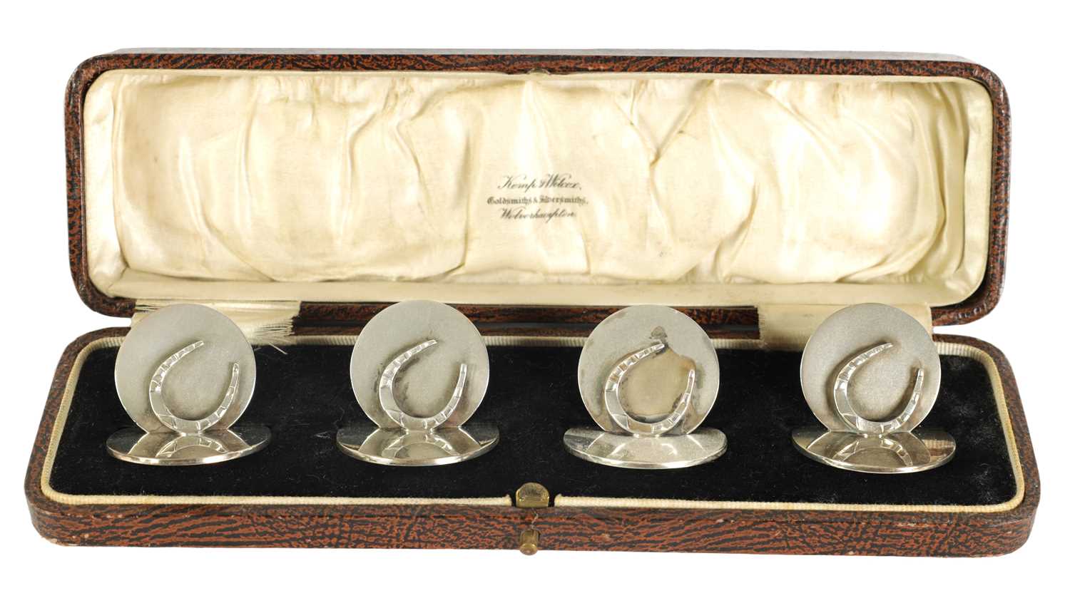 A CASED SET OF FOUR NOVELTY HORSESHOE MENU HOLDERS