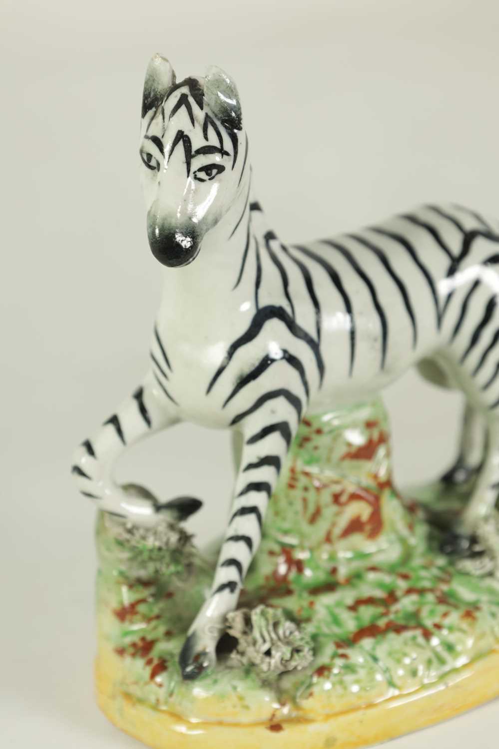 AN EARLY 19TH CENTURY STAFFORDSHIRE MODEL OF A ZEBRA, A STAFFORDSHIRE FIGURAL PEPPERETTE, A BLUE AND - Image 3 of 25