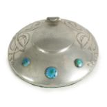 AN ARTS AND CRAFTS TUDRIC PEWTER CIRCULAR INK WELL AND LINER AFTER DESIGNS BY ARCHI BALD KNOX