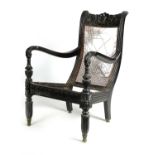 AN EARLY 19TH CENTURY SRI LANKAN/CEYLONESE SOLID EBONY BERGERE ARMCHAIR