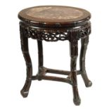 A 19TH CENTURY OVAL CARVED HARDWOOD CHINESE TABLE