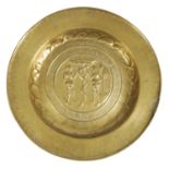 AN EARLY 17TH CENTURY NUREMBERG BRASS ALMS DISH