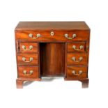 A GEORGE III MAHOGANY KNEEHOLE DESK