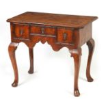 A GEORGE I FIGURED WALNUT AND HERRING-BANDED LOWBOY