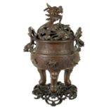 A 19TH CENTURY CHINESE BRONZE CENSER AND LID MOUNTED ON A HARDWOOD STAND