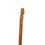 AN EARLY 19TH CENTURY CARVED WALKING STICK