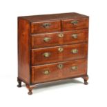 AN EARLY 18TH CENTURY QUEEN ANNE FIGURED WALNUT BACHELORS CHEST