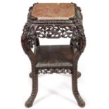 A 19TH CENTURY PROFUSELY CARVED CHINESE HARDWOOD SQUARE JARDINIERE STAND