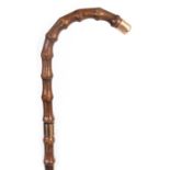 A LATE 19TH CENTURY 9CT GOLD TIPPED BAMBOO WALKING STICK BY BRIGG