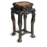 A 19TH CENTURY CHINESE PROFUSELY CARVED HARDWOOD JARDINIERE STAND