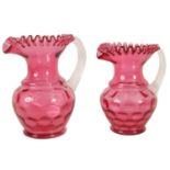 A GRADUATED PAIR OF 19TH CENTURY STYLE OVERSIZED CRANBERRY GLASS JUGS