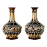 A GOOD PAIR OF DOULTON LAMBETH FOOTED BULBOUS FLARED NECK VASES BEARING MONOGRAM FOR GEORGE TINWORTH