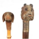 TWO EARLY 20TH CENTURY DOG’S HEAD HANDLED WALKING STICKS