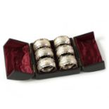A CASED SET OF SIX VICTORIAN SILVER SERVIETTE RINGS