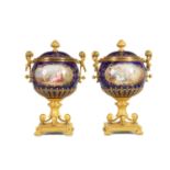A FINE PAIR OF 19TH CENTURY ORMOLU AND SEVRES PORCELAIN TWO HANDLED VASE AND COVERS