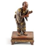 A JAPANESE MEIJI PERIOD BRONZE AND GILT FIGURAL SCULPTURE SIGNED MIYAO