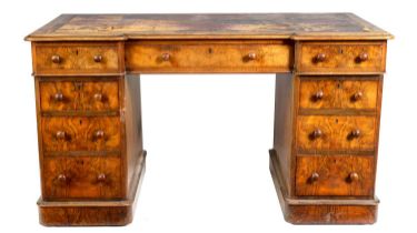 A MID 19TH CENTURY FIGURED WALNUT BREAKFRONT PEDESTAL DESK