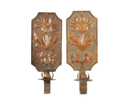 A MATCHED PAIR OF ARTS AND CRAFTS COPPER WALL SCONCES