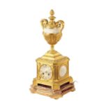 A 19TH CENTURY ORMOLU AND ONYX PANELLED MANTEL CLOCK