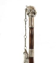 AN UNUSUAL 19TH CENTURY SILVER TOPPED WALKING STICK WITH HINGED SKULL POMMEL