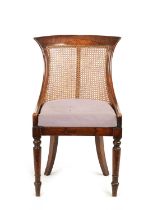 A REGENCY SIMULATED ROSEWOOD BERGERE LIBRARY CHAIR